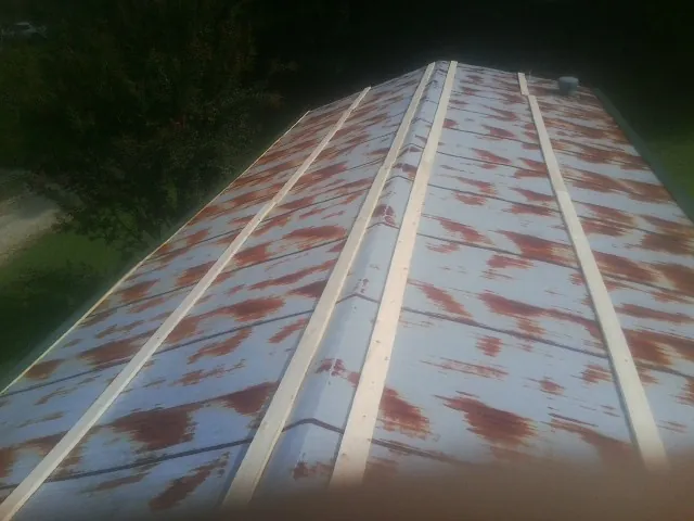 Rusted metal roof panels with new wood purlins before replacement — Storm Damage Roof Repair in Rye Beach by Roofing Brothers